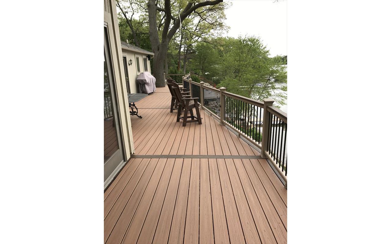 Deck on Middle Straits Lake in West Bloomfield, MI., constructed out of Trex Transcend Tropical decking in Tiki Torch / Spiced Rum; complimented by Trex Rope Swing railing w/ black balusters.