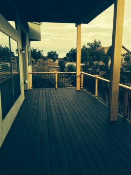 Prescott AZ. Lava Rock with groove, hidden clips. Trex joist tape. Metal railing and redwood top cap.