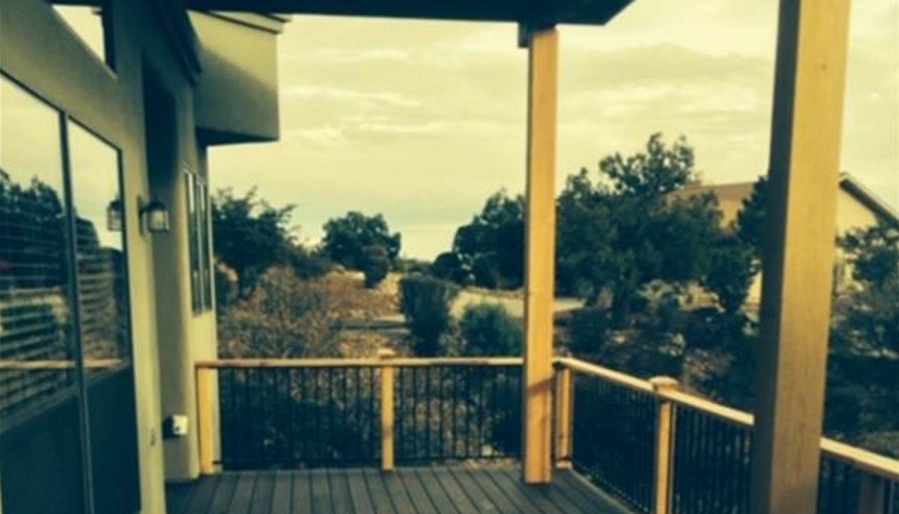 Prescott AZ. Lava Rock with groove, hidden clips. Trex joist tape. Metal railing and redwood top cap.