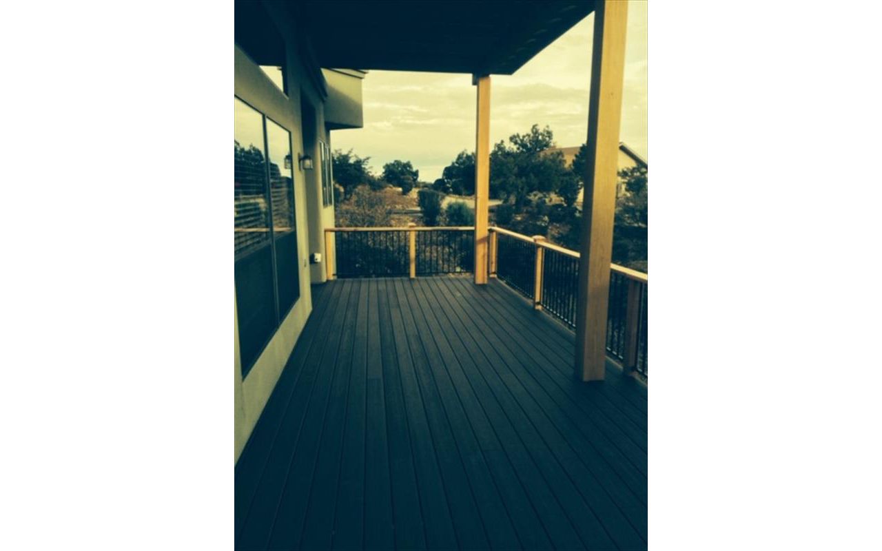 Prescott AZ. Lava Rock with groove, hidden clips. Trex joist tape. Metal railing and redwood top cap.