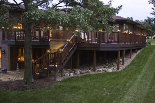 Wrap around deck featuring Trex Transcend Vintage Lantern decking with Trex Vintage Lantern Transcend Railing. Low-voltage LED Trex cap lights sets this deck off for a magnificent display at night.