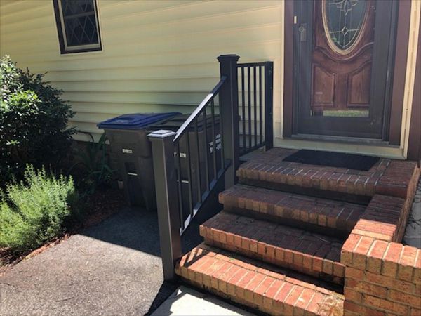 Trex Signature Black railings with Transcend Black posts look perfect with this brick entrance