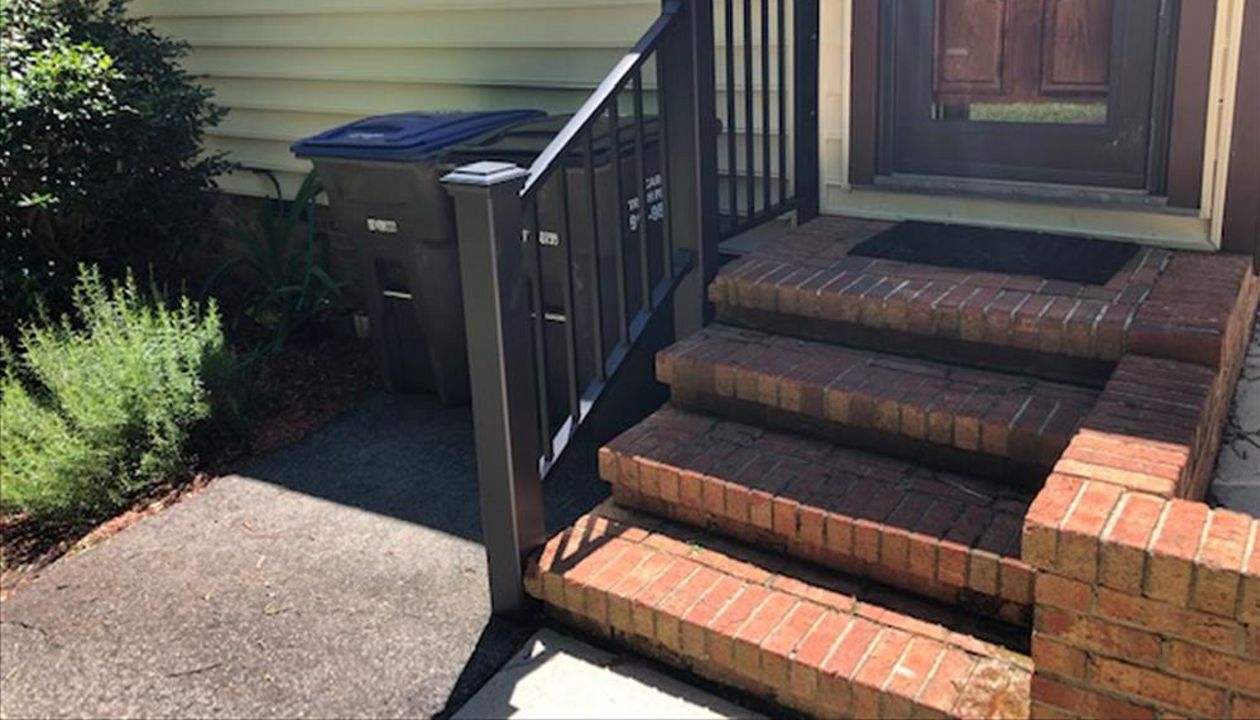 Trex Signature Black railings with Transcend Black posts look perfect with this brick entrance