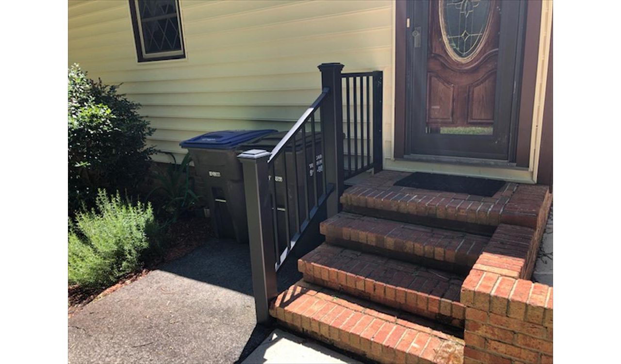 Trex Signature Black railings with Transcend Black posts look perfect with this brick entrance