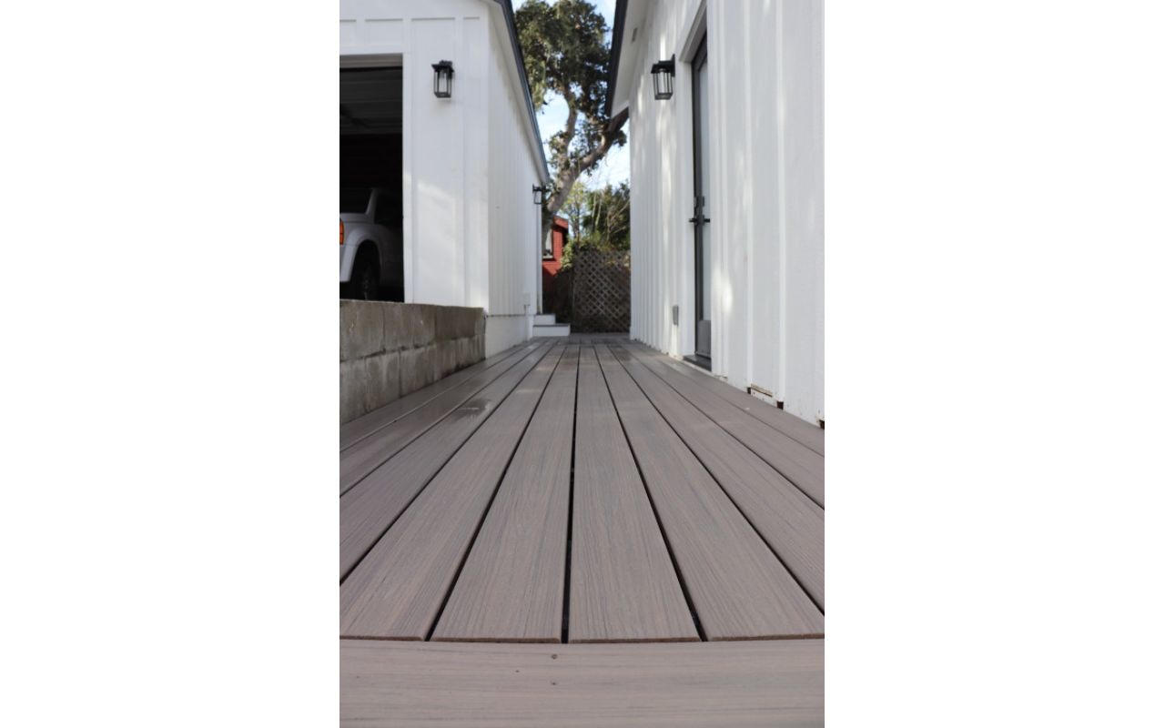 Closeup of Rocky Harbour decking with a white base and black trim house