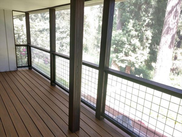 Trex Savanna Gold Decking, Lava Rock post wraps, on a screened in deck.