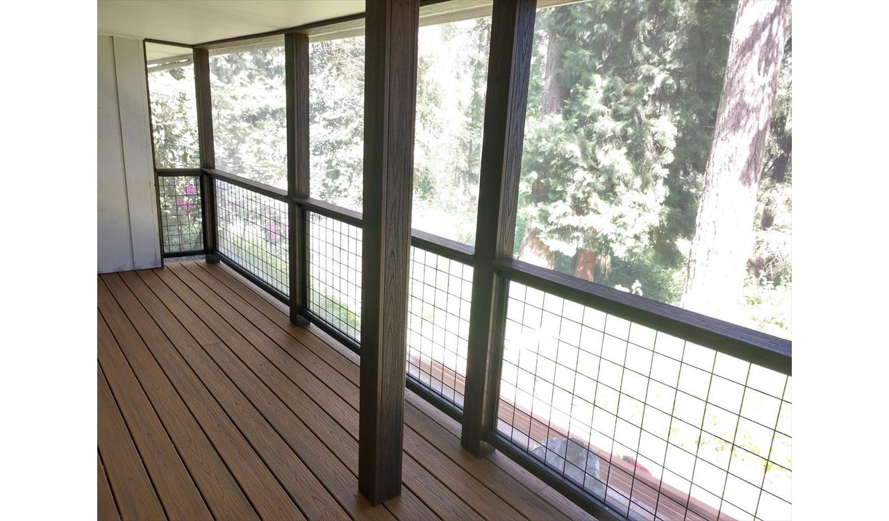 Trex Savanna Gold Decking, Lava Rock post wraps, on a screened in deck.
