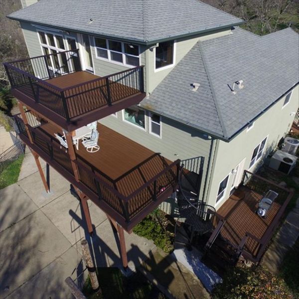 Three tiered custom Trex Deck in Saddle, Black Transcend Railing with Cocktail top rails.