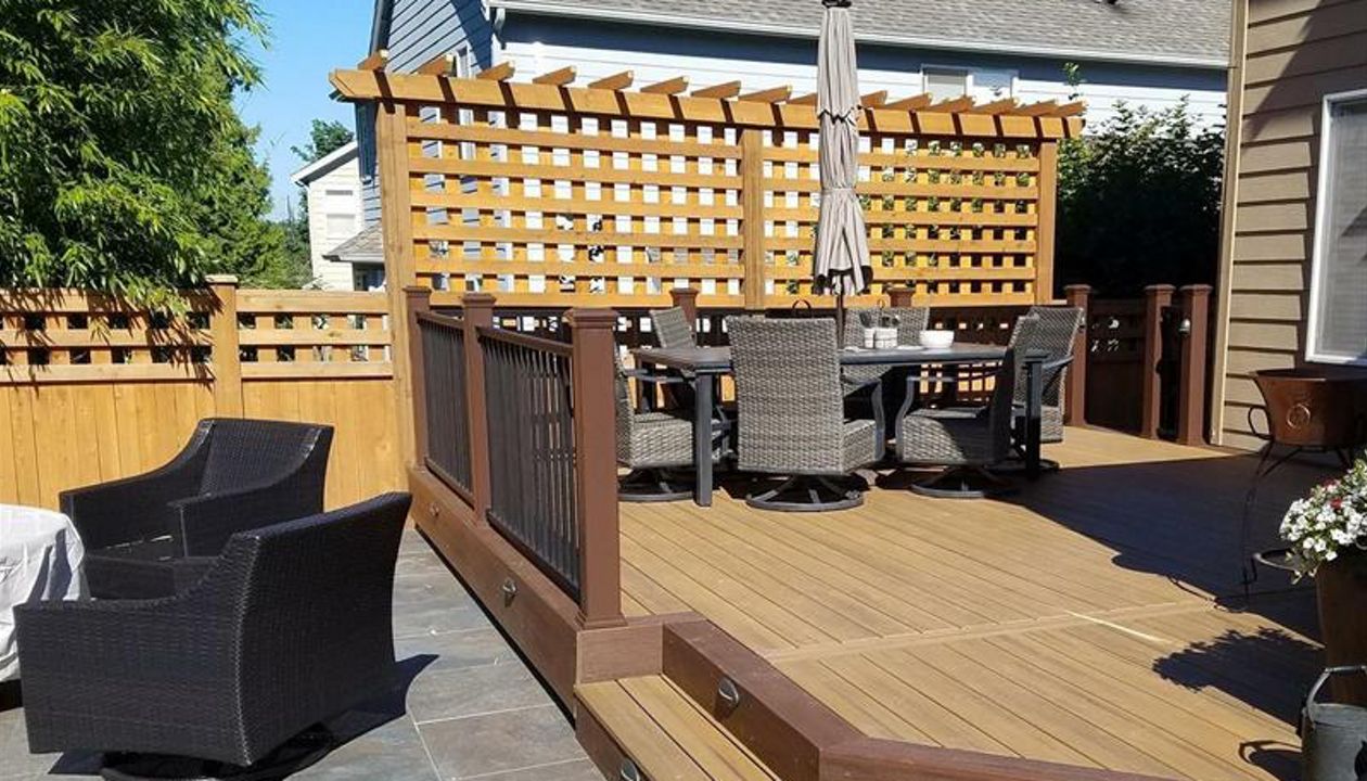 Trex Transcend Tropical Havana Gold with Spiced Rum border and fascia with a lower porcelain slab deck bordered by Trex Transcend Spiced Rum fascia.