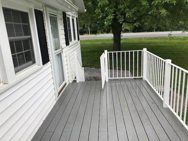 Trex Select Pebble Grey deck looks great with the color scheme of this home.
