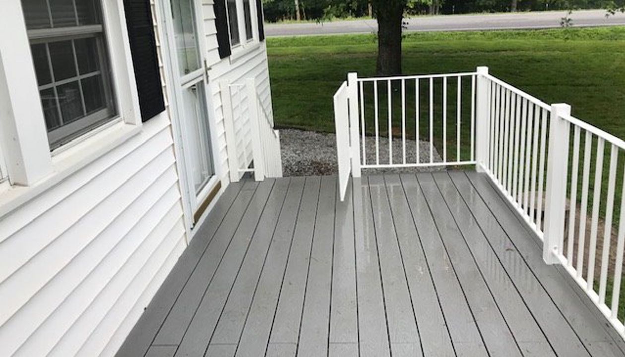 Trex Select Pebble Grey deck looks great with the color scheme of this home.