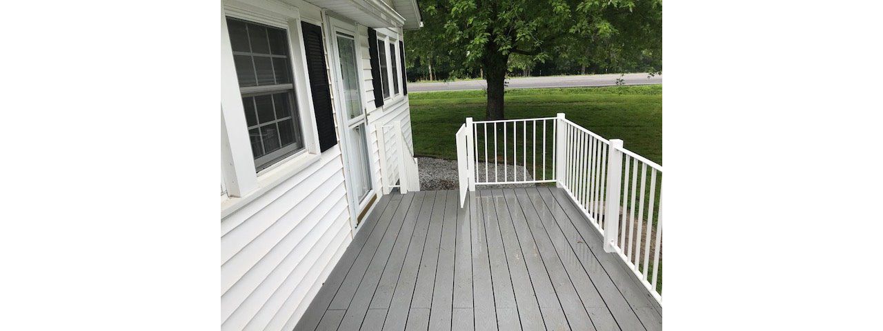 Trex Select Pebble Grey deck looks great with the color scheme of this home.