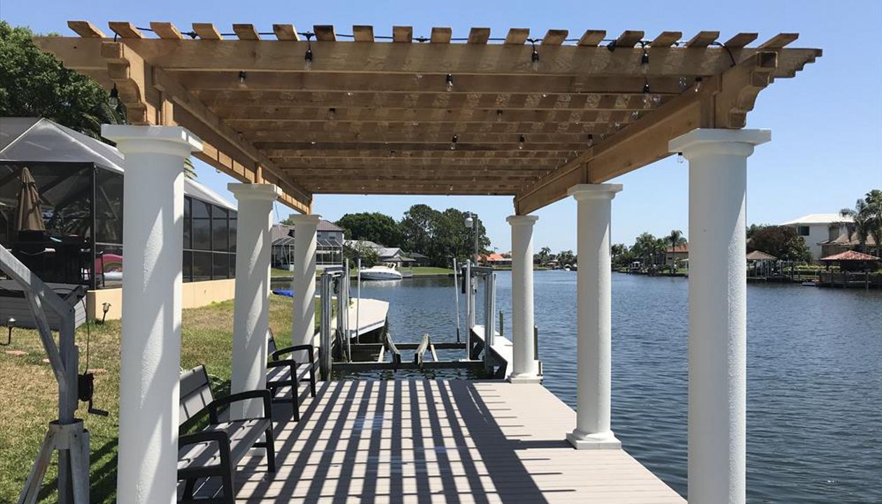 Water views are great. They are even better with Trex composite decking which allows you to spend more time enjoying your dock than maintaining it. Plus the shade from this cyress pergola is just enough to allow this area to be enjoyed all day long!