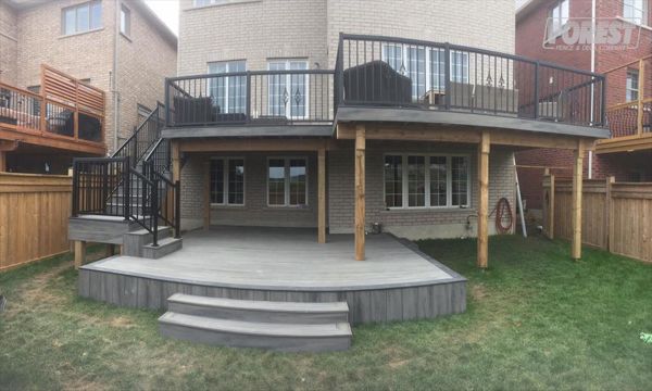 Island Mist TREX Deck. Two tiered deck, with black railing. Built in:  Aurora, King City, Oak Ridges, Richmond Hill, Newmarket, Toronto, Mississauga, Mount Albert, Vaughan, Bradford, Stouffville