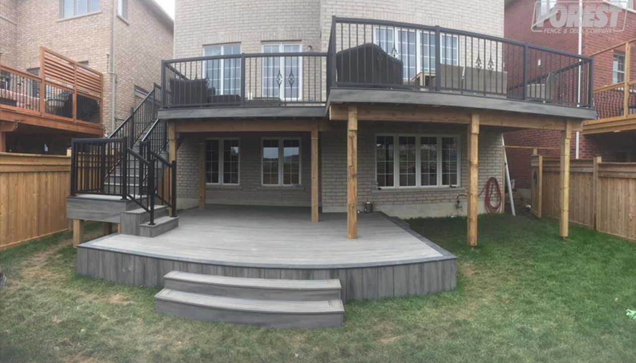 Island Mist TREX Deck. Two tiered deck, with black railing. Built in:  Aurora, King City, Oak Ridges, Richmond Hill, Newmarket, Toronto, Mississauga, Mount Albert, Vaughan, Bradford, Stouffville