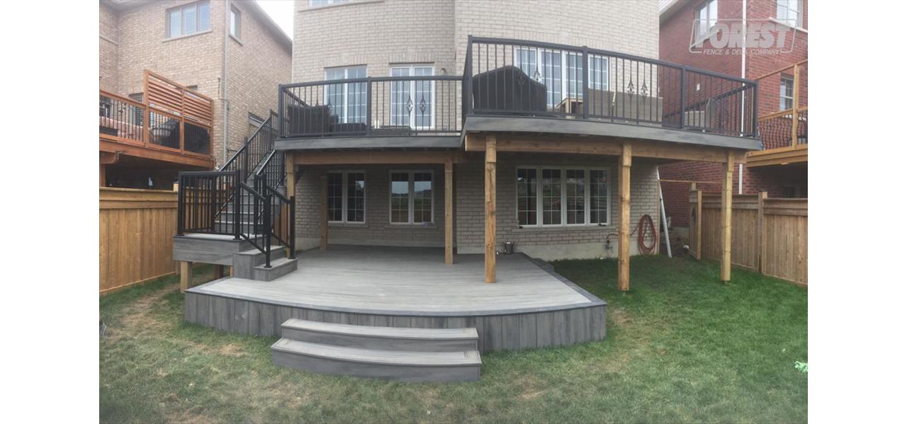 Island Mist TREX Deck. Two tiered deck, with black railing. Built in:  Aurora, King City, Oak Ridges, Richmond Hill, Newmarket, Toronto, Mississauga, Mount Albert, Vaughan, Bradford, Stouffville
