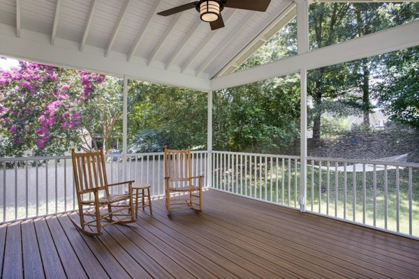 Screened in porch with decking in Trex Foggy Wharf with two Adirondack chairs looking out on the yard