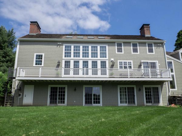 Cantilevered deck with white railings, Redding, CT, Trex Transcend spiced rum