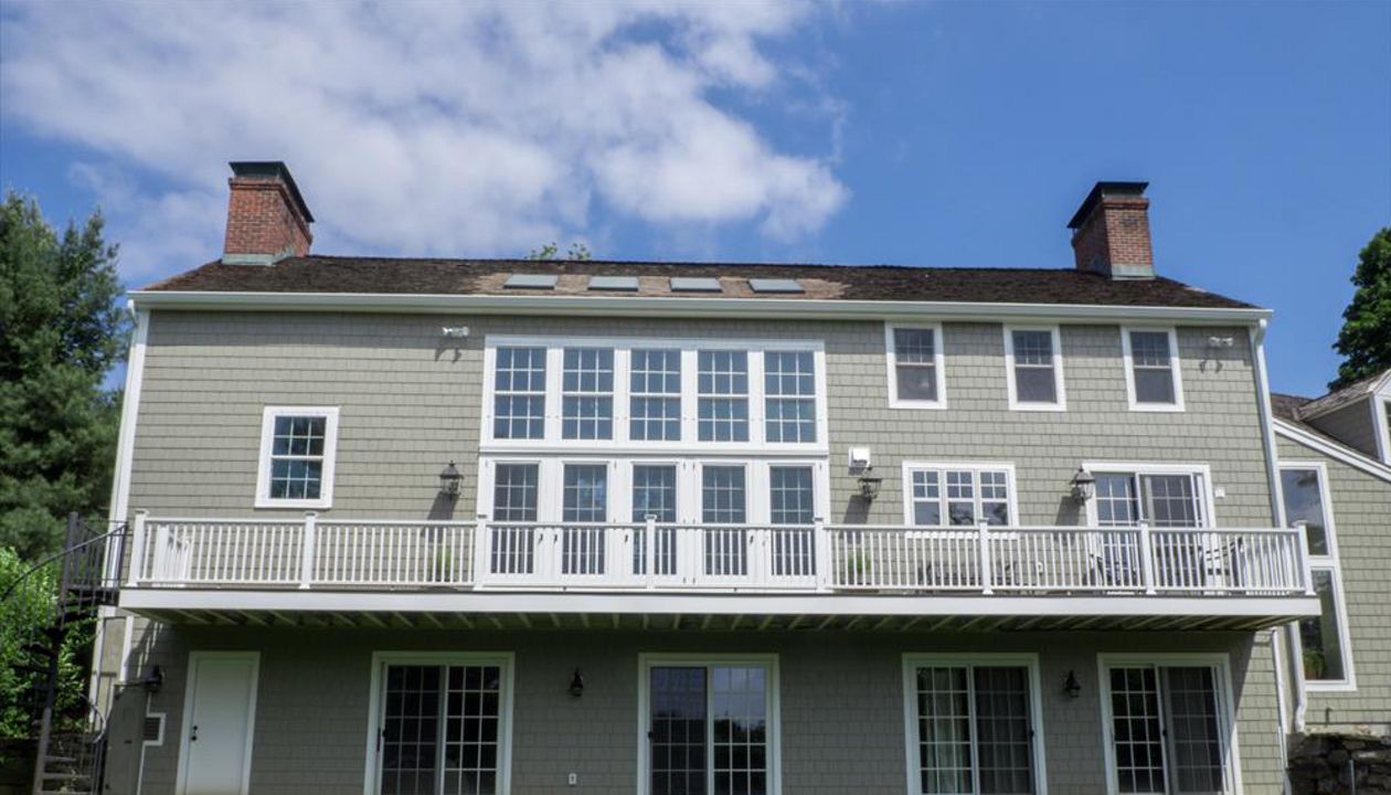 Cantilevered deck with white railings, Redding, CT, Trex Transcend spiced rum