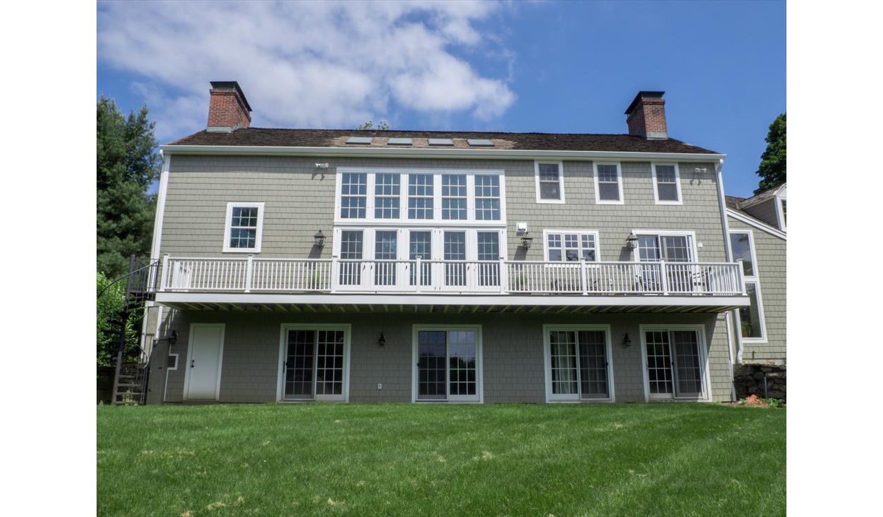 Cantilevered deck with white railings, Redding, CT, Trex Transcend spiced rum