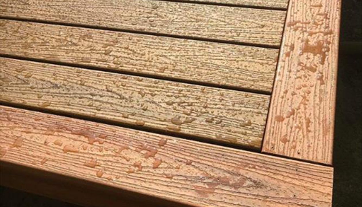 Trex Tropical Decking. Havana Gold inlay with Tiki Torch picture frame accent