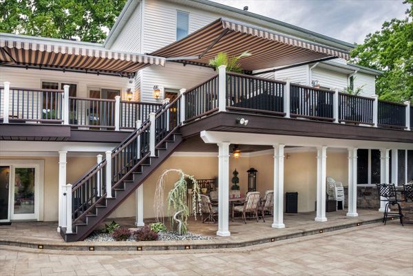 White post rail lights figuratively — and literally — brighten the darker undertones of this massive Manalapan, N.J., outdoor space done in both Spiced Rum (decking) and Vintage Lantern (border/fascia).
