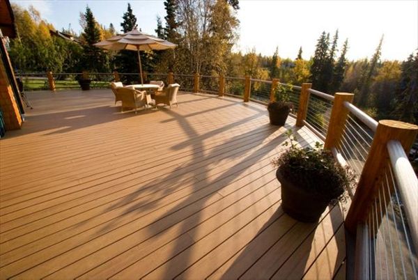 Curved decking with cable railing, by Treeline Construction