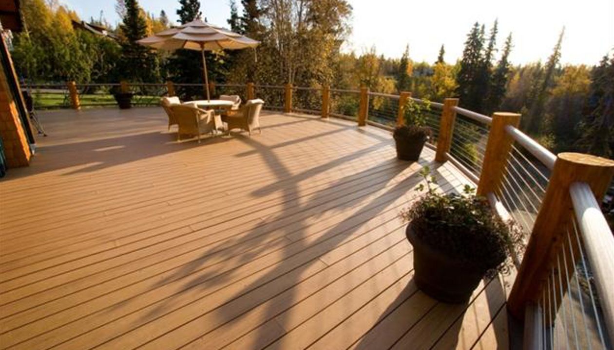 Curved decking with cable railing, by Treeline Construction