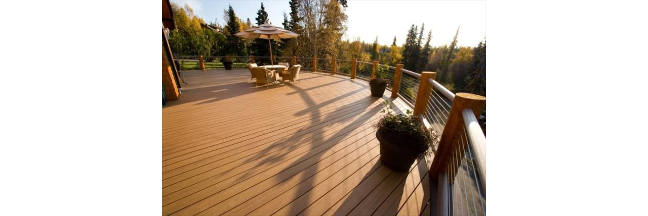 Curved decking with cable railing, by Treeline Construction