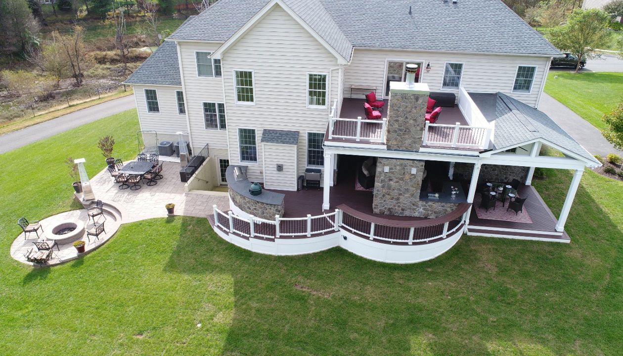 Trex Curved Deck with Open Porch, Fireplace, Outdoor Kitchen, & Paver Patio