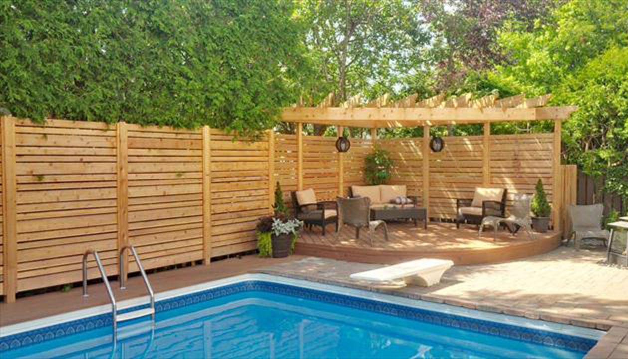 Tiki Torch sitting area by the pool; curved fascia