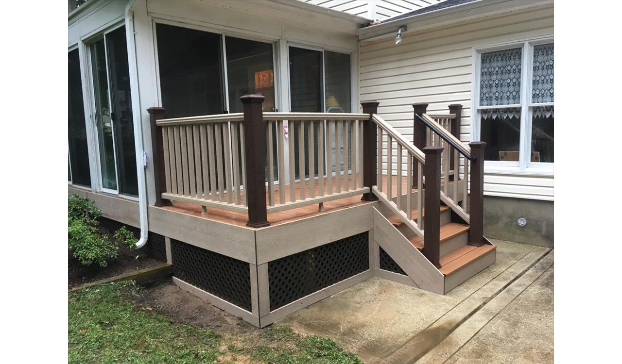 This deck highlights the ease of  customization with the Trex Transcend railing. This homeowner wanted a unique look so we paired Rope Swing rails with Vintage Lantern Posts. We also picture framed the lattice with Rope Swing fascia. Tiki Torch decking.