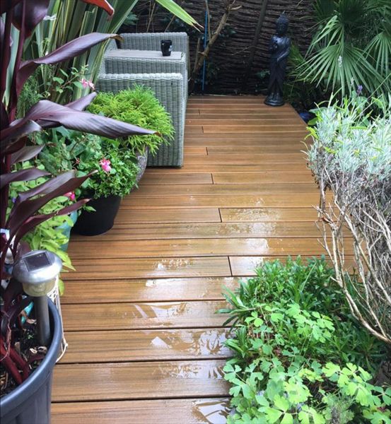 Trex Contours Torinho Brown. Lots of natural planting and a small pond really make this deck stand out.