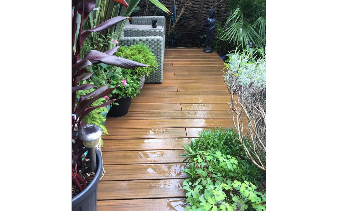 Trex Contours Torinho Brown. Lots of natural planting and a small pond really make this deck stand out.