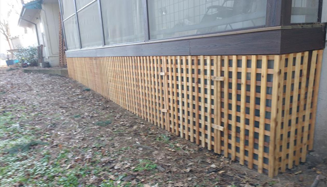 Trex Savanna Gold Decking, Lava Rock post wraps, on a screened in deck.