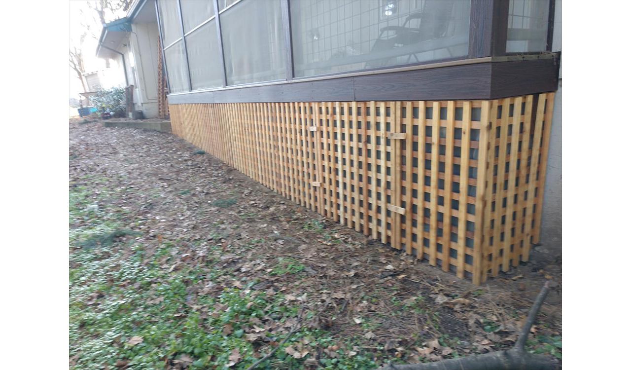 Trex Savanna Gold Decking, Lava Rock post wraps, on a screened in deck.