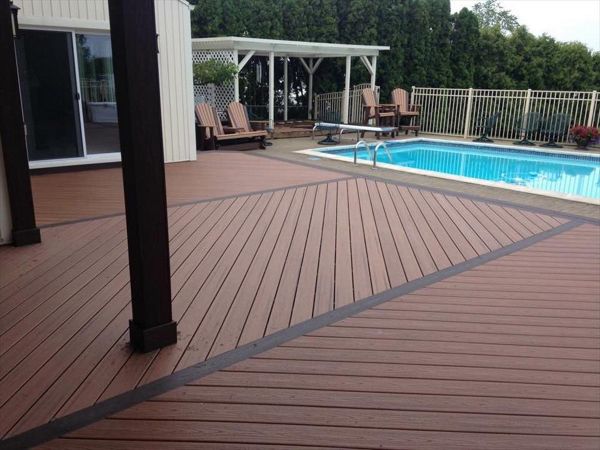 Wouldn't you like to relax on this pool deck?! This deck is made up of tiki torch Trex transcends decking and angled vintage lantern decking. Installed with Goliath Tech helical piers in Salem Township, MI.