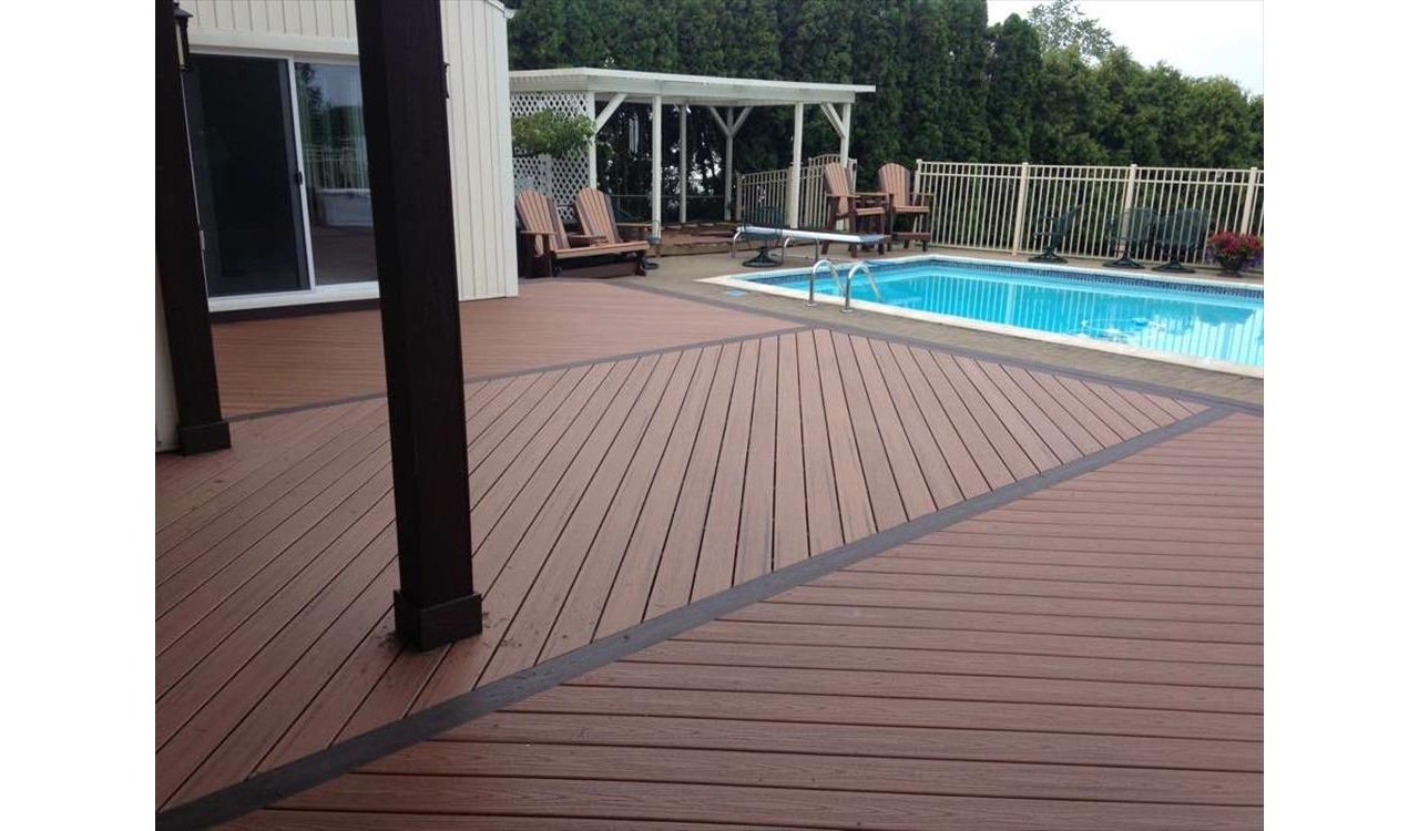 Wouldn't you like to relax on this pool deck?! This deck is made up of tiki torch Trex transcends decking and angled vintage lantern decking. Installed with Goliath Tech helical piers in Salem Township, MI.
