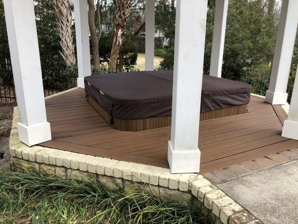 Hot tub surround with removable access panel in Landfall
