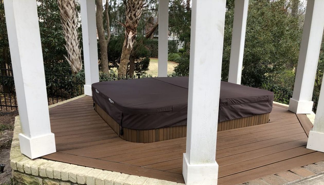 Hot tub surround with removable access panel in Landfall