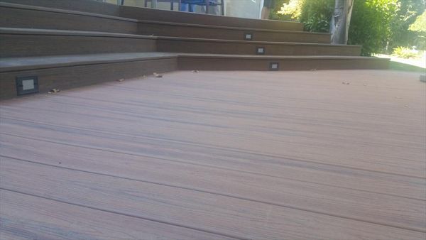 Custom Trex deck in Tiki Torch and Spiced Rum in Redding. Stairs have lighting and unique angles set to match the house.  Majestic Builders is proud to provide top quality composite decks that will last a lifetime.
