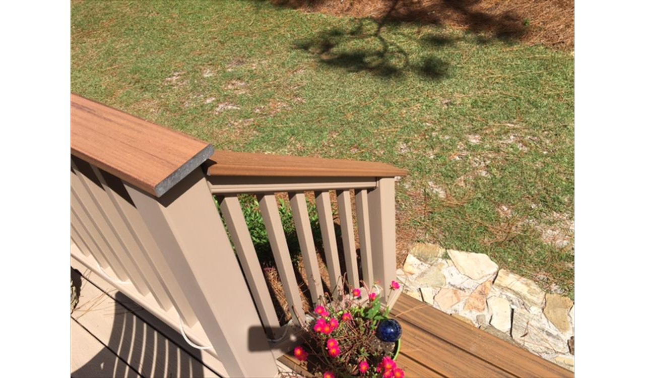 Trex Havana Gold cocktail railing cap finishes off the look of this Rope Swing railing.