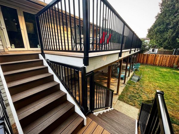 Toasted Sand field, and risers, Spiced Rum bordering. This deck is 100% waterproof via Trex Rainescapes and provides a significant amount of dry usable space beneath.