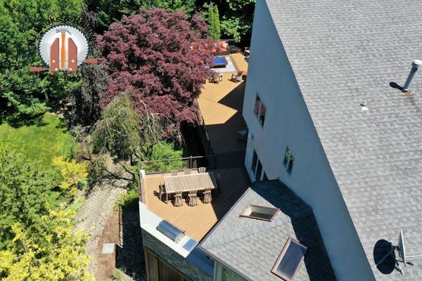 A very large deck in Havana Gold with Spiced Rum featuring a built in kitchen and firepit area