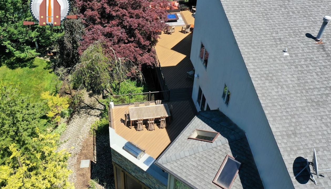 A very large deck in Havana Gold with Spiced Rum featuring a built in kitchen and firepit area