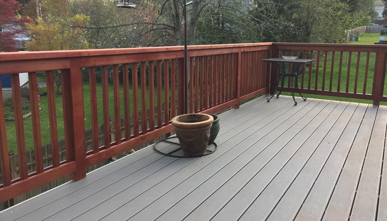 Pebble grey decking with cherrywood stained rails