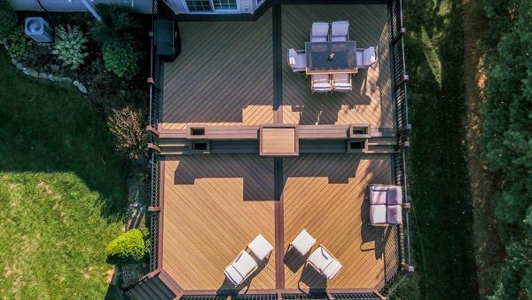 Sleek modern deck with multiple seating areas for outdoor dining and lounging.