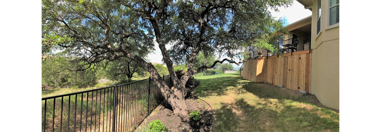 Shaded backyard with a Trex Transcend Tiki Torch composite deck, Austin, Texas