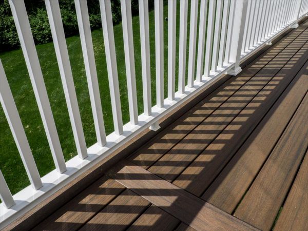 Cantilevered deck with white railings, Redding, CT, Trex Transcend spiced rum