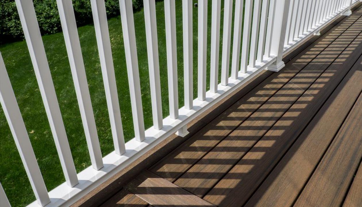 Cantilevered deck with white railings, Redding, CT, Trex Transcend spiced rum